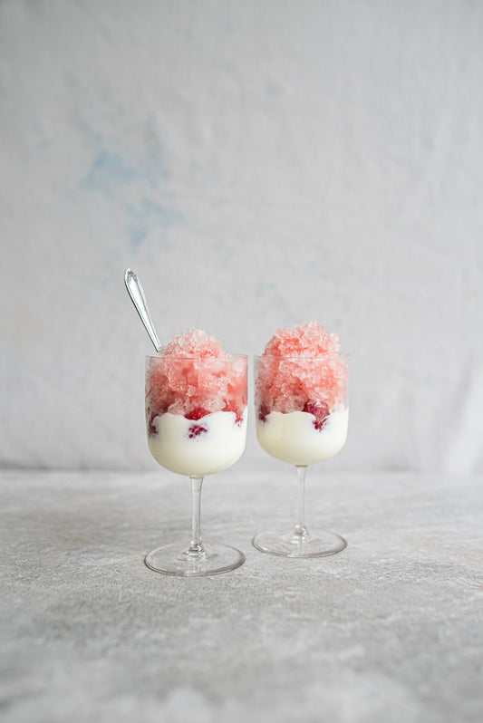 All About Kombucha’s probiotic dessert creation — layers of creamy kombucha yogurt, fresh berries, and a pink kombucha granita topping, served elegantly in wine glasses for a refreshing gut-friendly treat.