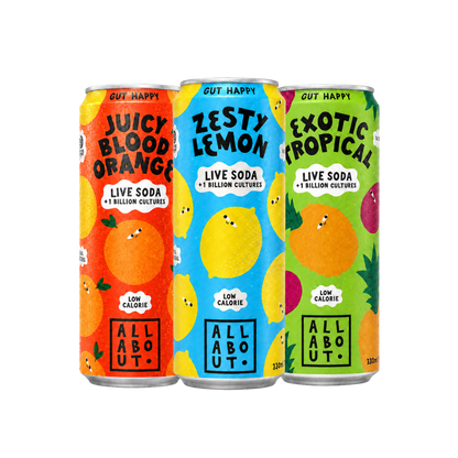 Three colourful soda cans labeled 'Juicy Blood Orange', 'Zesty Lemon', and 'Exotic Tropical' with playful fruit illustrations on a transparent background.