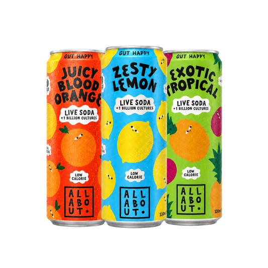 Three colourful soda cans labeled 'Juicy Blood Orange', 'Zesty Lemon', and 'Exotic Tropical' with playful fruit illustrations on a transparent background.