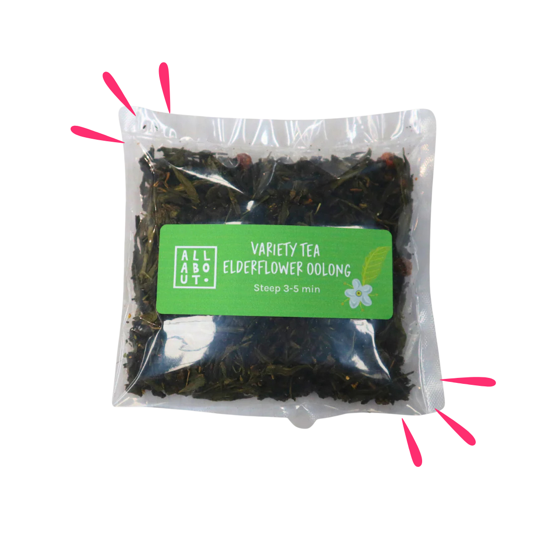 All About Kombucha variety tea pouch labeled Elderflower Oolong in a clear 3–5 minute steeping pack with green label, showing loose tea leaves and floral ingredients