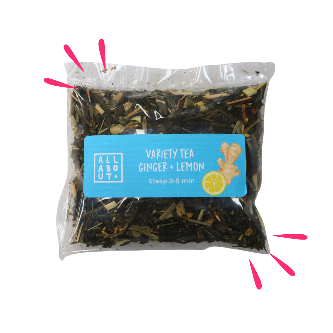 All About Kombucha variety tea pouch labeled Ginger + Lemon in a clear steeping pack with blue label, featuring ginger and lemon illustrations and loose herbal tea blend