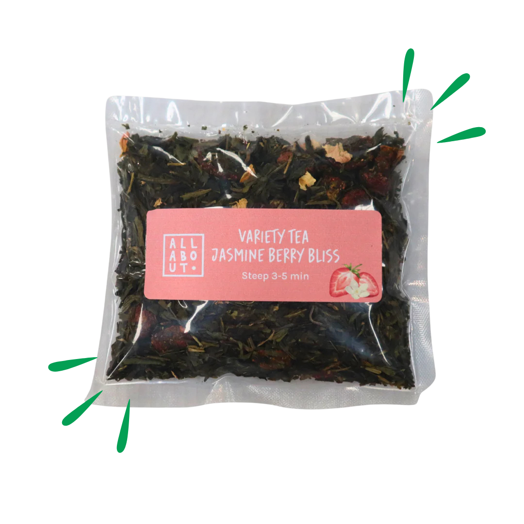 All About Kombucha variety tea pouch labeled Jasmine Berry Bliss in a clear 3–5 minute steeping pack with a pink label, containing loose tea leaves and dried berries.