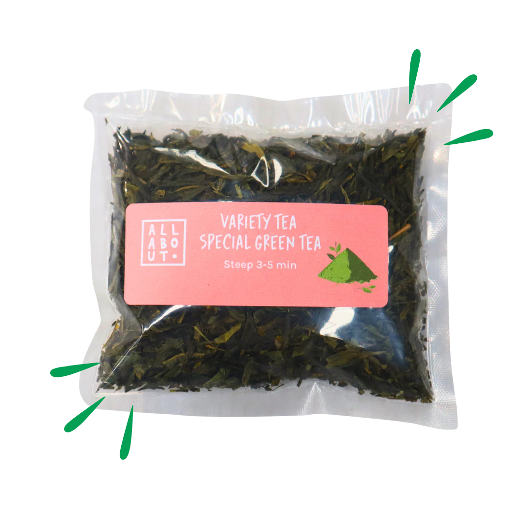 All About Kombucha variety tea pouch labeled Special Green Tea in a clear pack with pink label, steep time 3–5 minutes, showing loose green tea leaves.